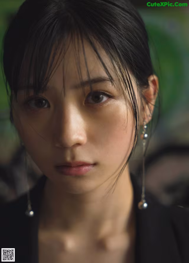A close up of a woman with long black hair.
