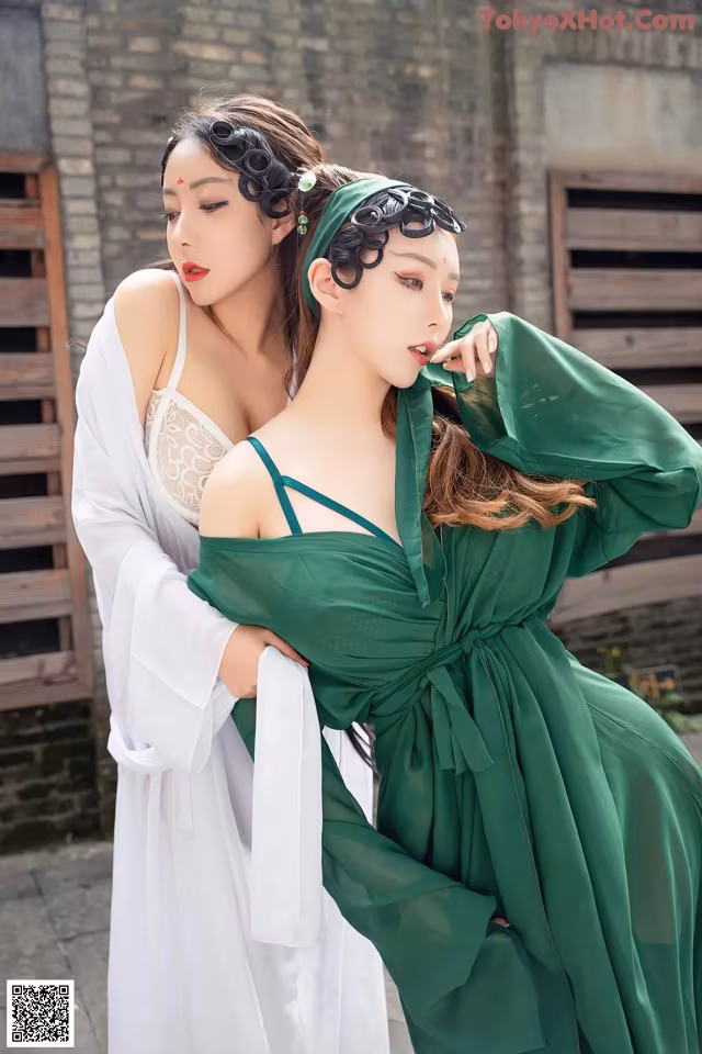 A woman in a green dress and a woman in white dress.