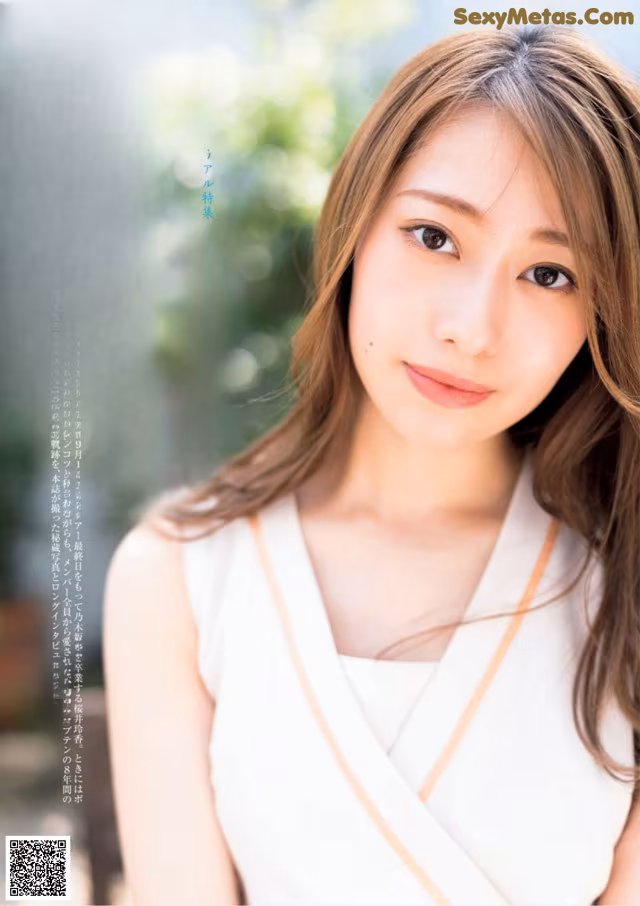 A woman in a white dress is posing for a magazine cover.